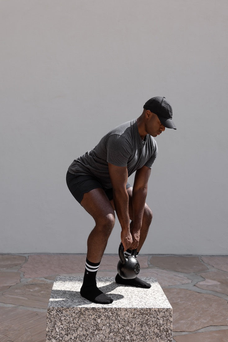 Man lifting weight in grip socks