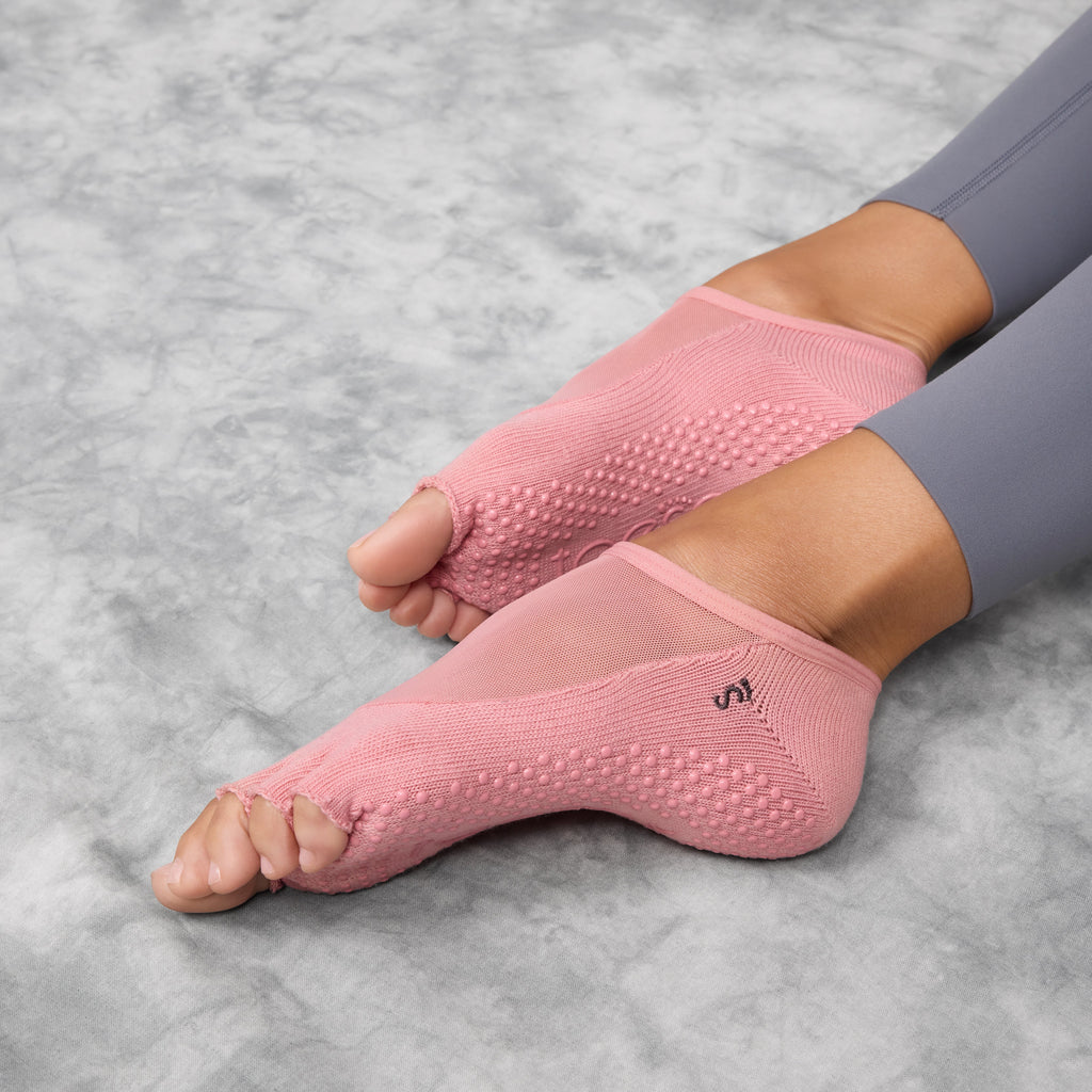 Pink pilates socks with non-slip sole on a white background