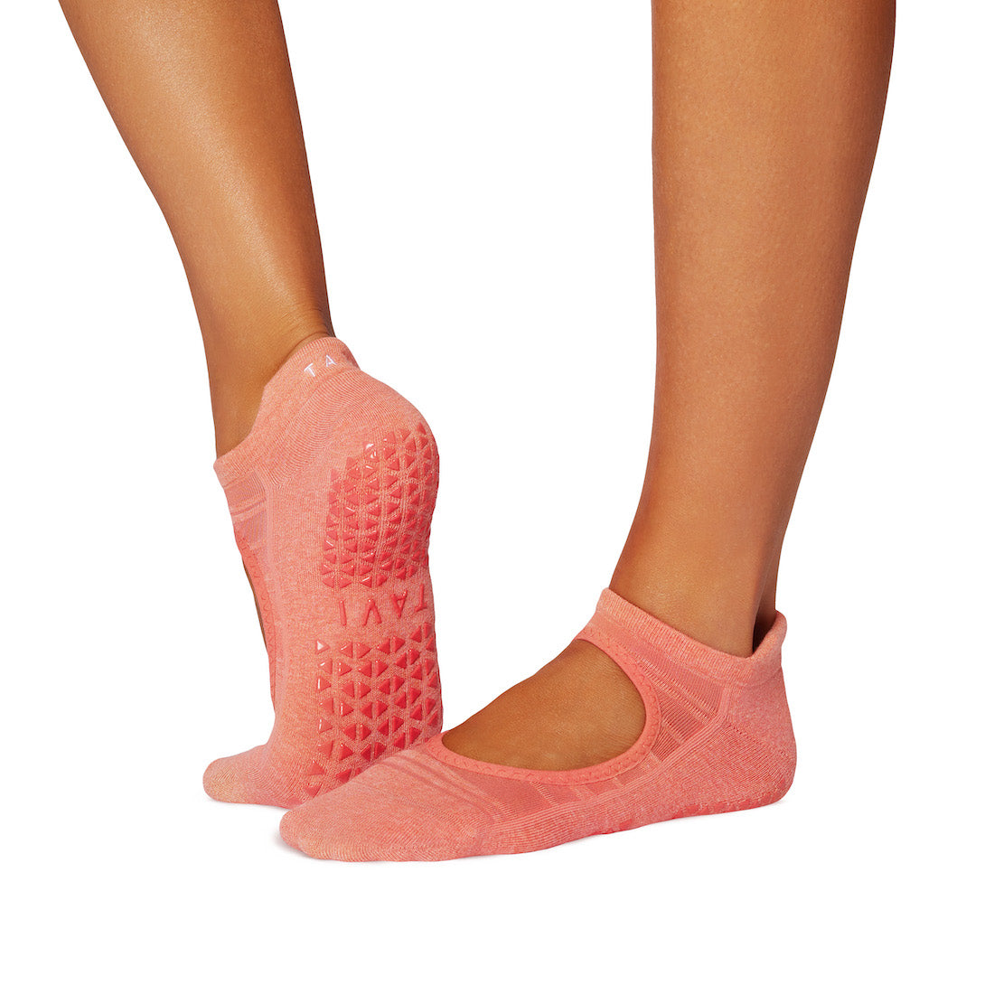 Pink grip socks worn by a person on a white background