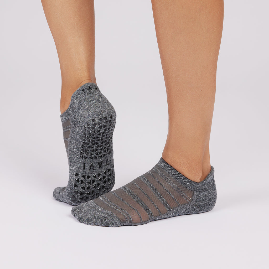 Gray ankle socks with textured pattern worn by a person on a light gray background