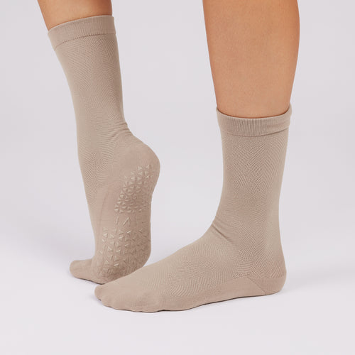 Beige socks with non slip sole on a white background