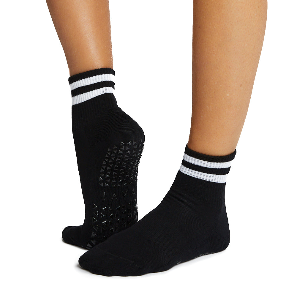 Black socks with white stripes worn by a person on a white background