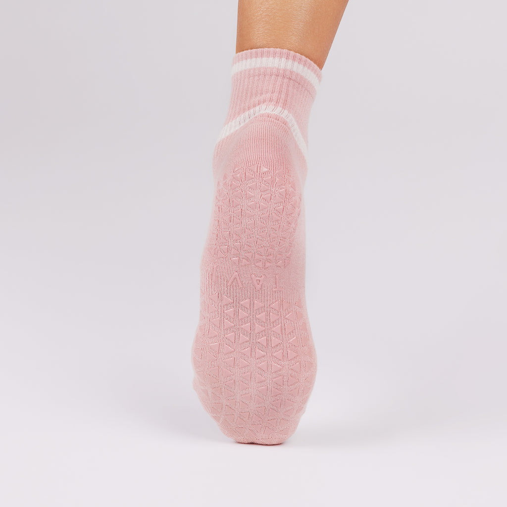 Pink non slip sole sock on a light gray background