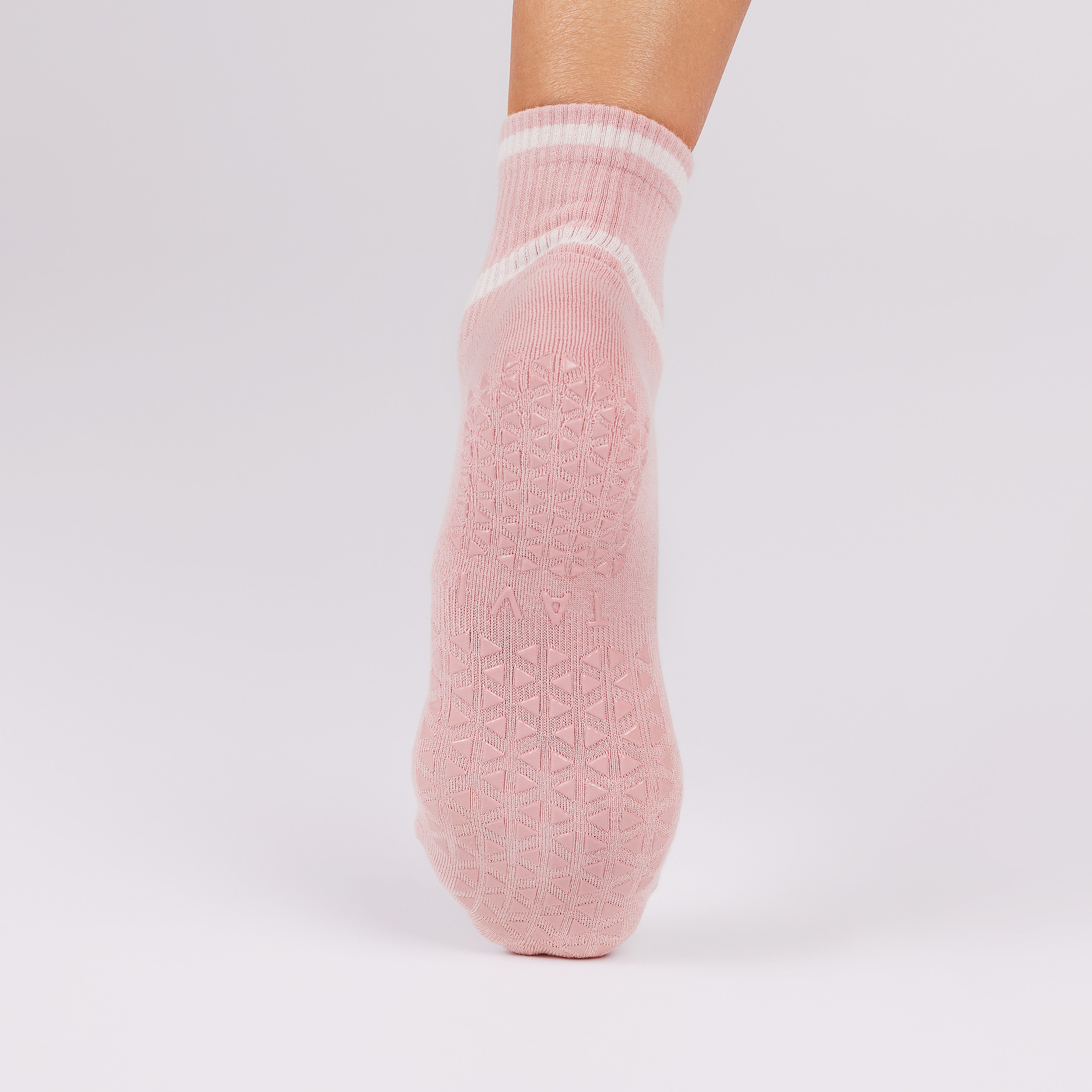 Pink non slip sole sock on a light gray background
