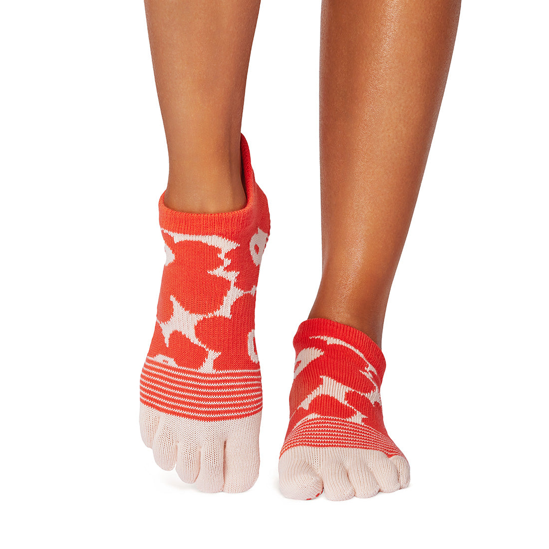 Red toe-separated socks with white patterns on a white background