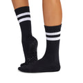 Black socks with white stripes worn by a person on a white background