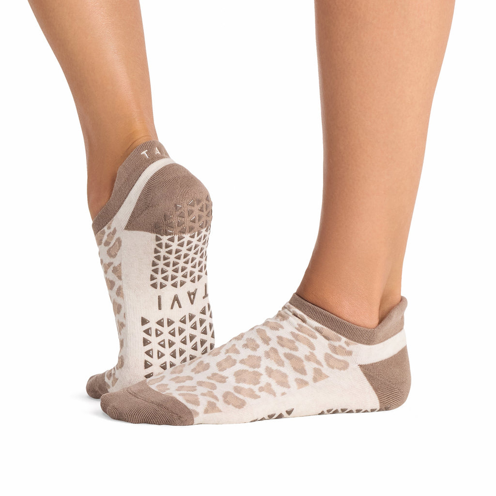 Tavi Grip Savvy Socks in Leopard sand – worn on feet, side view