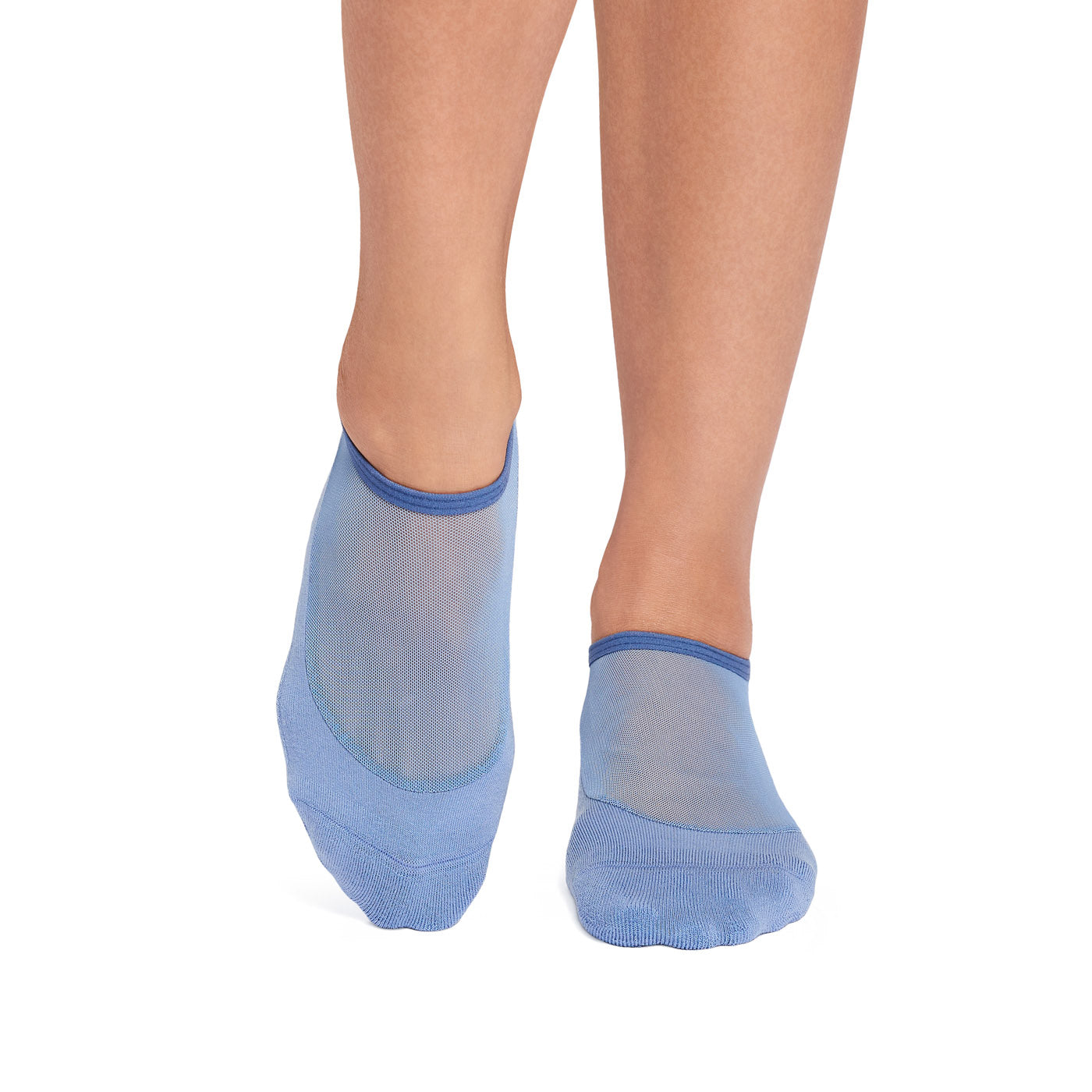 Blue sheer grip socks worn with a white background