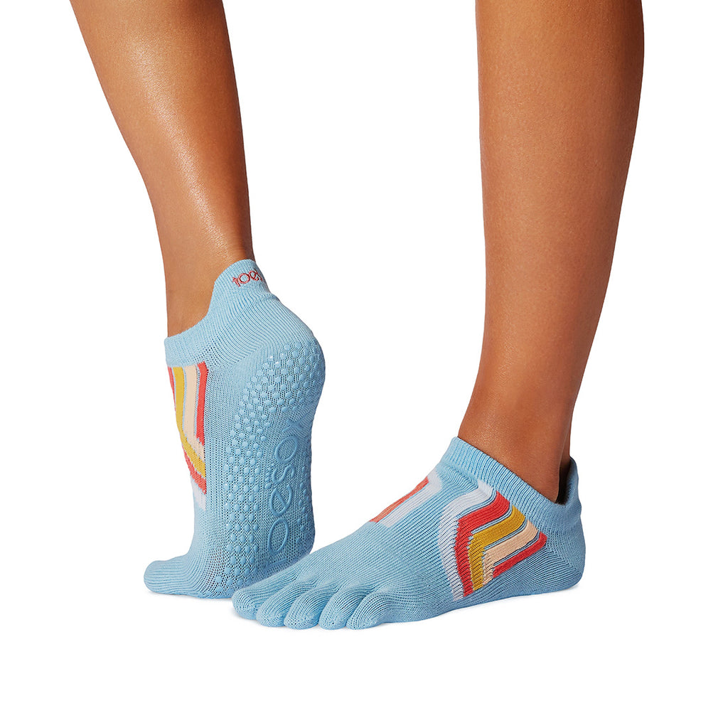 Blue toe-separated socks with colorful accents worn by a person on a white background