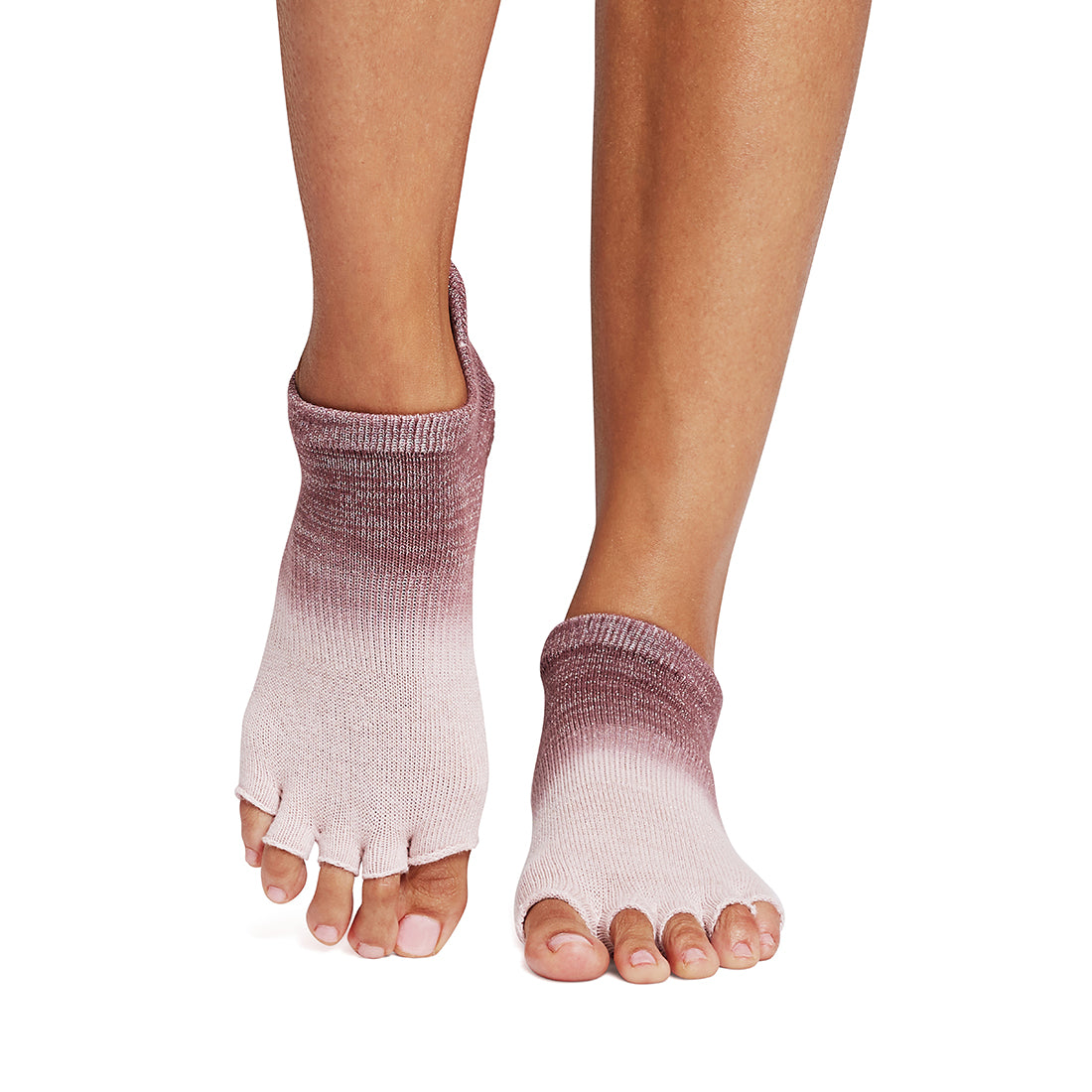 Person wearing pink and purple gradient half toe socks on a white background